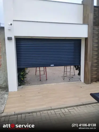 Porta de enrolar azul escura em entrada residencial